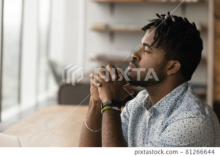 Thoughtful African male employee looks into distance and thinking Thoughtful African male employee looks into distance and thinking 81266644