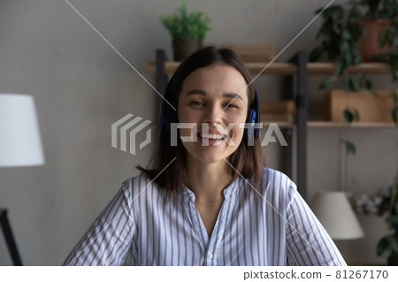 Portrait of smiling young woman in headphones have webcam call 81267170
