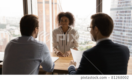 Rear back view HR male managers interviewing African female applicant 81268002