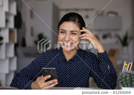 Happy Indian woman use cellphone browsing web 81268008