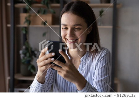 Smiling woman use cellphone speak on webcam call 81269132