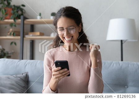 Happy woman holding smartphone read sms great news celebrate success Happy woman holding smartphone read sms great news celebrate success 81269136