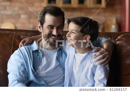 Smiling father and teen son have fun together 81269157
