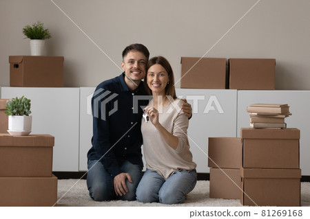 Young couple showing keys feel happy on moving day 81269168