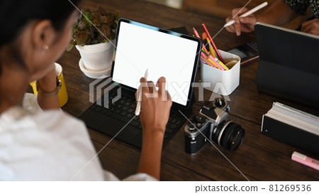Cropped shot of photographer and creative designer working together with digital tablet. Cropped shot of photographer and creative designer working together with digital tablet. 81269536