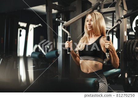 Fitness woman in sport outfit exercising in gym Fitness woman in sport outfit exercising in gym 81270250