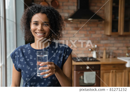 Happy young African mixed race woman drinking fresh water Happy young African mixed race woman drinking fresh water 81271232