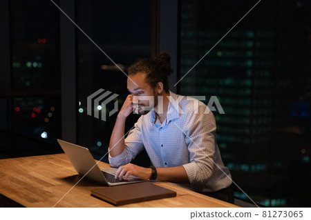 African businessman stay late in modern office working using computer 81273065