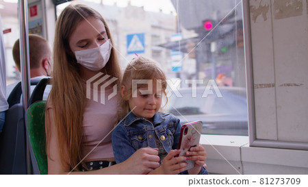 Tired sleepy woman with daughter going home by bus after hard work day, child kid play on smartphone Tired sleepy woman with daughter going home by bus after hard work day, child kid play on smartphone 81273709