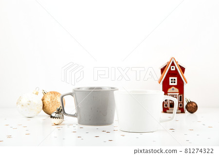 White and gray empty cup mockup on light background with Christmas decorations. Minimalistic mug mock up White and gray empty cup mockup on light background with Christmas decorations. Minimalistic mug mock up 81274322