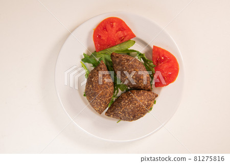 Traditional kebbe and pita bread on big round plate in lebanese restaurant 81275816