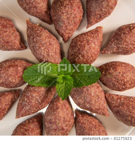 Traditional kebbe and pita bread on big round plate in lebanese restaurant Traditional kebbe and pita bread on big round plate in lebanese restaurant 81275823