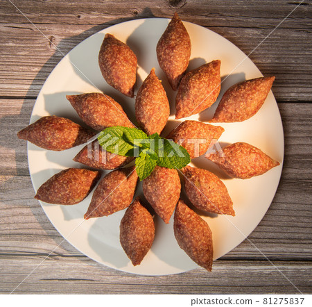 Traditional kebbe and pita bread on big round plate in lebanese restaurant Traditional kebbe and pita bread on big round plate in lebanese restaurant 81275837