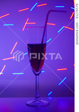 glass of cocktail with background. A glass on the bar in a cafe, restaurant, nightclub or disco. Glass or stemware with alcohol or a cocktail on a colored background. glass of cocktail with background. A glass on the bar in a cafe, restaurant, nightclub or disco. Glass or stemware with alcohol or a cocktail on a colored background. 81276579