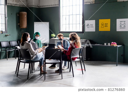 Men and women sitting in circle during group therapy, reading and talking. Coronavirus concept. Men and women sitting in circle during group therapy, reading and talking. Coronavirus concept. 81276860