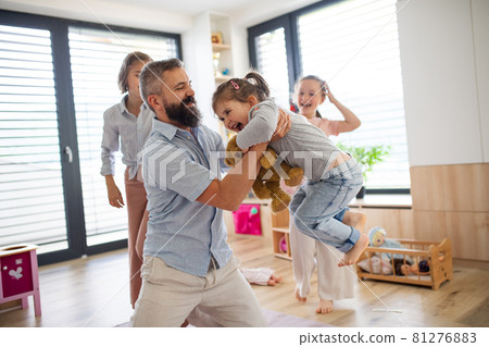 Father with three daughters indoors at home, playing on floor. Father with three daughters indoors at home, playing on floor. 81276883