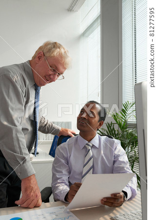 Business Team Looking at Report Business Team Looking at Report 81277595
