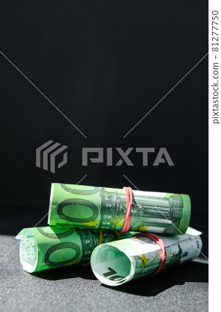 Close up of Euro money roll. Euro banknote set cash money - EU currency. Rolled with rubber euro notes. Banknotes stacked on each other in different positions Close up of Euro money roll. Euro banknote set cash money - EU currency. Rolled with rubber euro notes. Banknotes stacked on each other in different positions 81277750