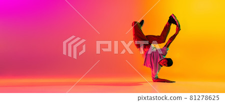 Flyer with young stylish man, break dancing dancer training in casual clothes isolated over gradient pink yellow background at dance hall in neon light. Flyer with young stylish man, break dancing dancer training in casual clothes isolated over gradient pink yellow background at dance hall in neon light. 81278625