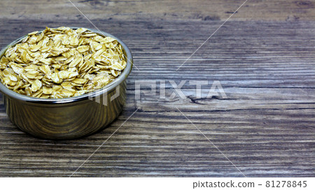 oatmeal or hercules flake close-up on a plate on wooden background. Healthy diet. Oatmeal porridge. 81278845