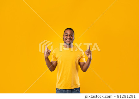 Happy Black Man Pointing Fingers Up Showing Something, Yellow Background 81281291