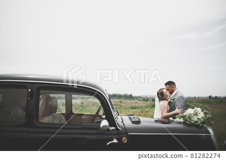 Caucasian happy romantic young couple celebrating their marriage. Outdoor Caucasian happy romantic young couple celebrating their marriage. Outdoor 81282274