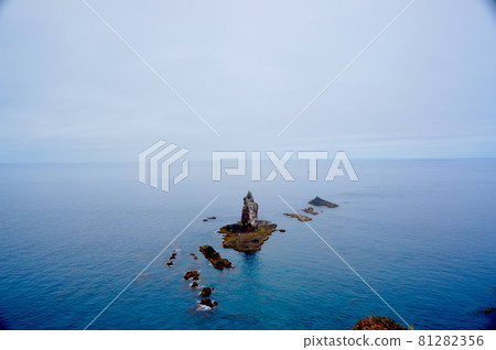 Rocks towering over the blue sea Rocks towering over the blue sea 81282356