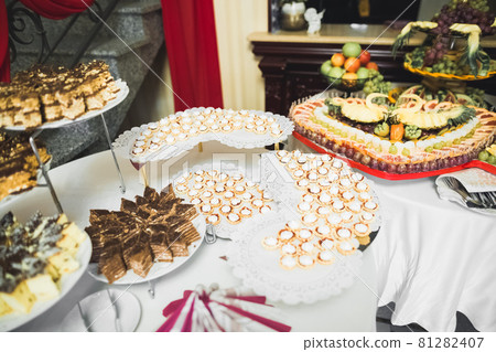 Delicious wedding reception candy bar dessert table Delicious wedding reception candy bar dessert table 81282407