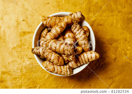 turmeric roots in a ceramic bowl turmeric roots in a ceramic bowl 81282534