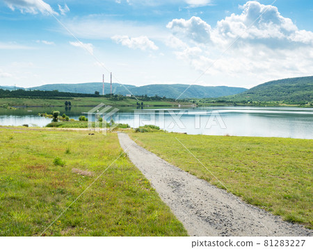 Milada lake, high chimneys of heating plant in Usti nad Labem city. Milada lake, high chimneys of heating plant in Usti nad Labem city. 81283227