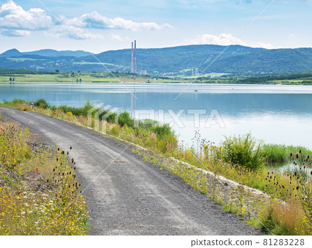 Milada lake, high chimneys of heating plant in Usti nad Labem city. Milada lake, high chimneys of heating plant in Usti nad Labem city. 81283228