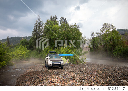Car camping at mountain river 81284447