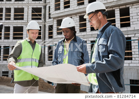 Construction Workers Holding Blueprint Construction Workers Holding Blueprint 81284714
