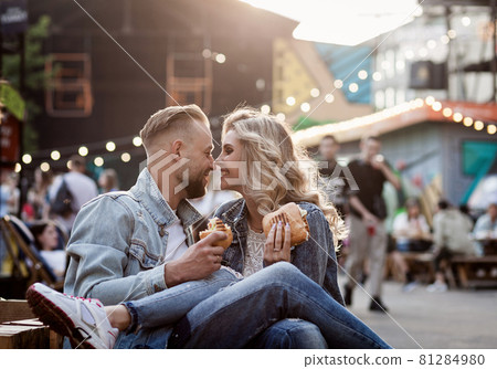 couple is relaxing in an open cafe 81284980