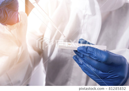 Checking the water quality. Scientist dripping a drop of water onto a test strip to determine the quality of water Checking the water quality. Scientist dripping a drop of water onto a test strip to determine the quality of water 81285832
