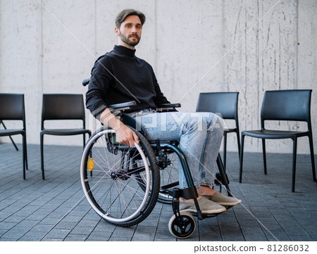 Portrait of sad man in wheelchair on group therapy, looking at camera. Portrait of sad man in wheelchair on group therapy, looking at camera. 81286032