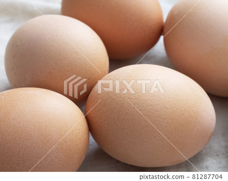Chicken eggs lie on a fabric surface, close-up. Multi-colored chicken eggs. Chicken eggs lie on a fabric surface, close-up. Multi-colored chicken eggs. 81287704
