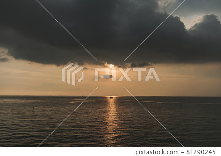 Small fishing hut in the middle of sunset and the sea. 81290245
