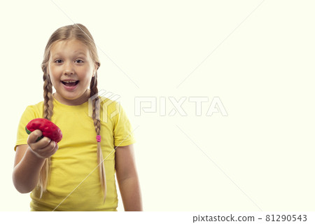 Anti-stress soft toy in the form of a red strawberry in the hands of a little caucasian girl on a white background with a place for text 81290543