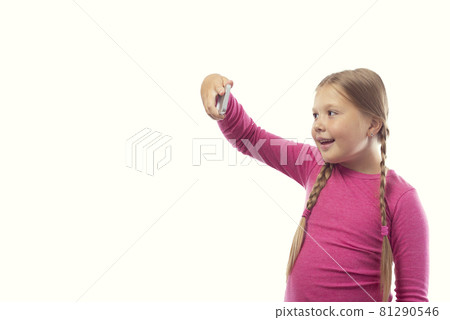 Cute little caucasian girl taking a photo using a modern smartphone on a white background Cute little caucasian girl taking a photo using a modern smartphone on a white background 81290546