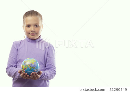 A cute little caucasian girl in a purple t-shirt holds an earth globe in her hands on a white background with a place for text A cute little caucasian girl in a purple t-shirt holds an earth globe in her hands on a white background with a place for text 81290549