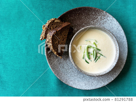 Clay bowl of Finnish salmon cream soup served with leek and croutons on green tablecloth background. Healthy food concept. Food background with copy space. Close up, selective focus. Clay bowl of Finnish salmon cream soup served with leek and croutons on green tablecloth background. Healthy food concept. Food background with copy space. Close up, selective focus. 81291788
