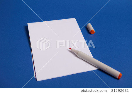 High angle view of a composition with watercolor marker or felt-tip pens on white blank sheet of paper with copy space for text isolated on blue background. 81292681