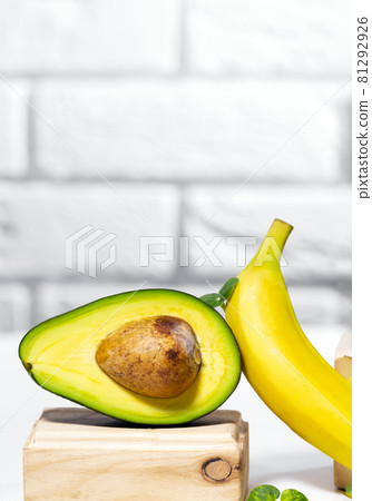 Creative avocado, banana and micro green balance wooden stands and podiums., white background, Equilibrium healthy food. Balanced nutrition concept 81292926
