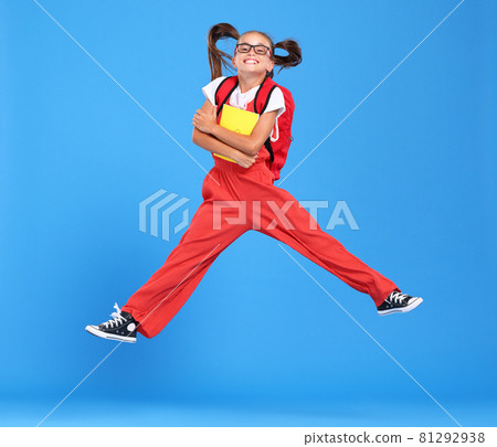 Energetic happy schoolgirl in eyewear with funny surprised facial expression jumping up in air 81292938