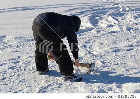 Chopping at an Old Ice Fishing Hole with an Axe Chopping at an Old Ice Fishing Hole with an Axe 81293798