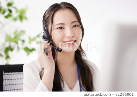 Young operator working in the office Young operator working in the office 81296001