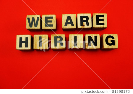 We are Hiring word created with cubes alphabet letters on red background We are Hiring word created with cubes alphabet letters on red background 81298173