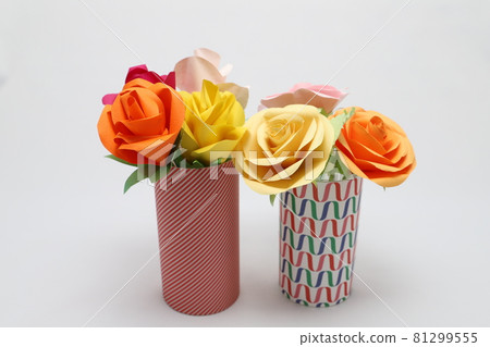 Handmade rose flowers made from origami are displayed in a beautiful vase 81299555