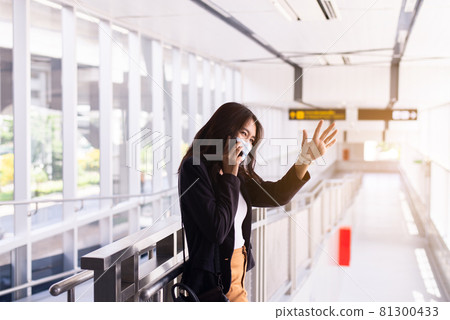 Beautiful asian woman raise up hands meeting,Happy greeting to her friends at train station Beautiful asian woman raise up hands meeting,Happy greeting to her friends at train station 81300433